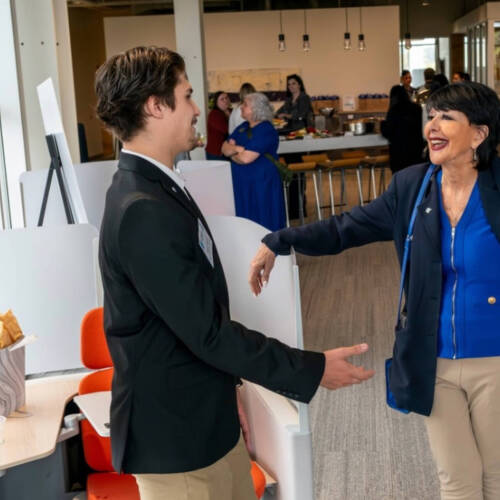Student talking to the President of GVSU